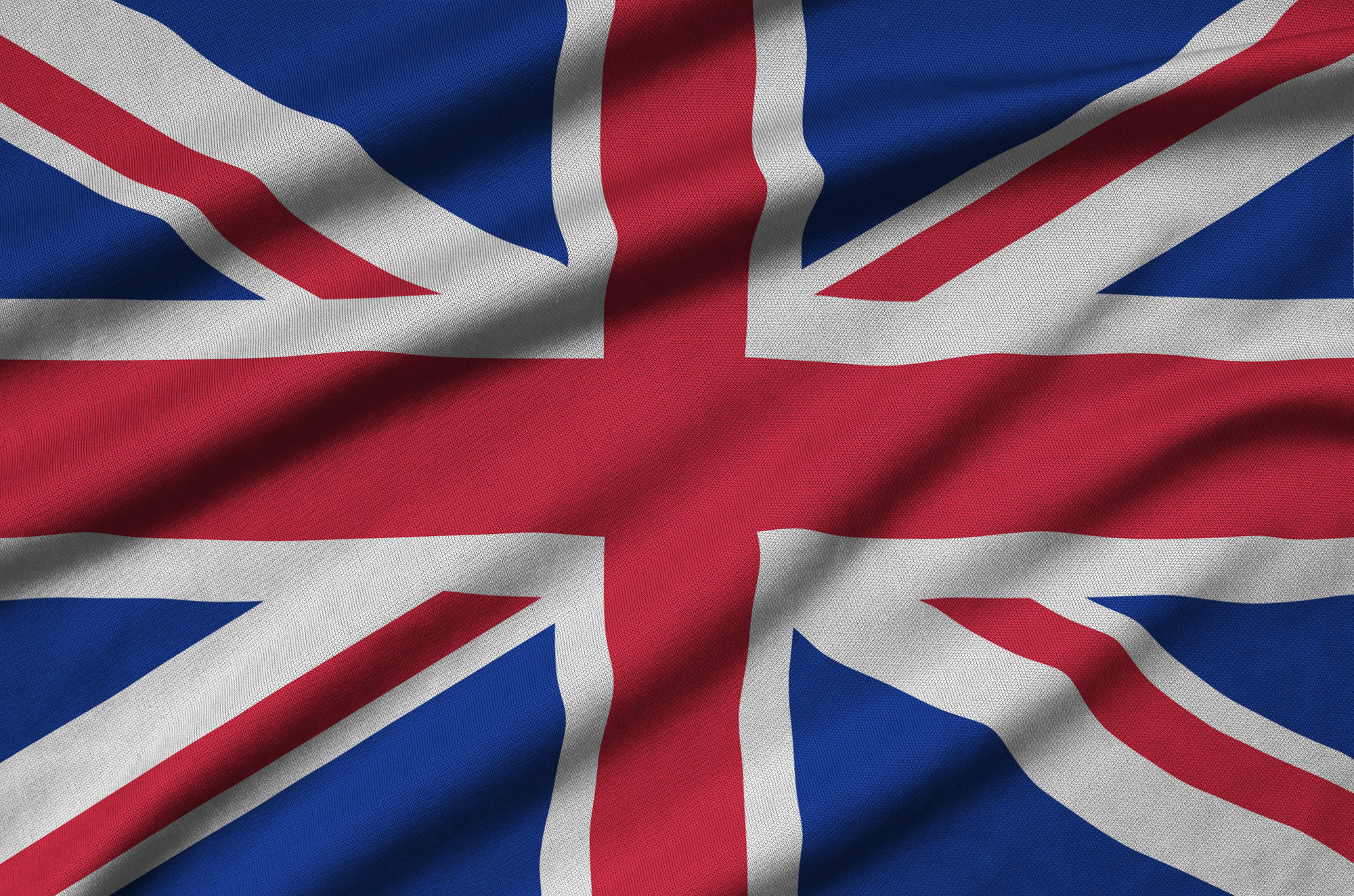 Great britain flag is depicted on a sports cloth fabric with many folds. Sport team waving banner