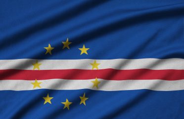 Cabo verde flag is depicted on a sports cloth fabric with many folds. Sport team waving banner