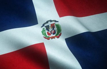 Closeup shot of the waving flag of Dominican Republic with interesting textures