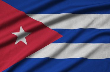 Cuba flag is depicted on a sports cloth fabric with many folds. Sport team waving banner