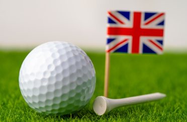 Golf ball with United kingdom flag on green lawn