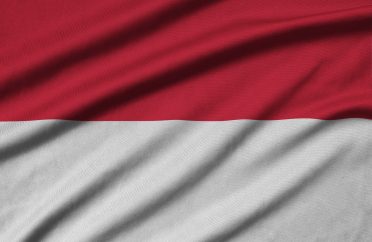 Indonesia flag is depicted on a sports cloth fabric with many folds. Sport team waving banner