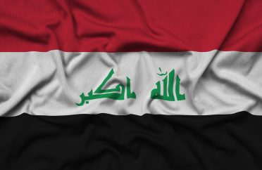 Iraq flag is depicted on a sports cloth fabric with many folds. Sport team waving banner