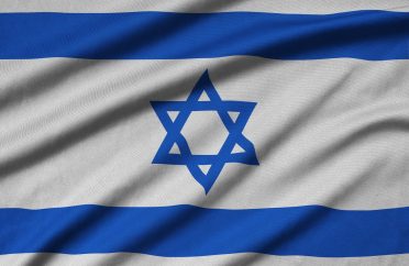 Israel flag is depicted on a sports cloth fabric with many folds. Sport team waving banner