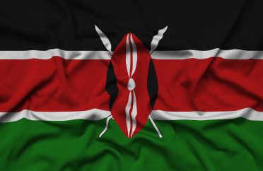 Kenya flag is depicted on a sports cloth fabric with many folds. Sport team waving banner