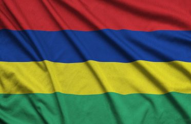 Mauritius flag is depicted on a sports cloth fabric with many folds. Sport team waving banner