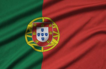 Portugal flag is depicted on a sports cloth fabric with many folds. Sport team waving banner