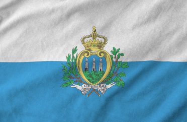 San Marino flag depicted on folded wavy fabric of old cloth