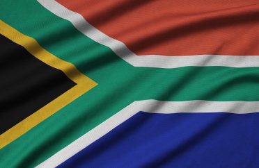 South Africa flag is depicted on a sports cloth fabric with many folds. Sport team waving banner