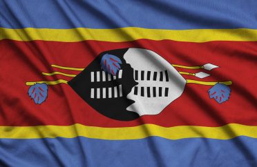 Swaziland flag is depicted on a sports cloth fabric with many folds. Sport team waving banner