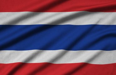 Thailand flag is depicted on a sports cloth fabric with many folds. Sport team waving banner