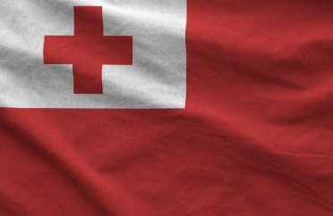 Tonga flag depicted on folded wavy fabric of old cloth